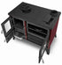 A red and black wood-burning stove with glass doors open, showing the interior shelves and drawer, photographed on a white background.