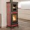 Wood-burning stove with red and black design in a modern kitchen setting