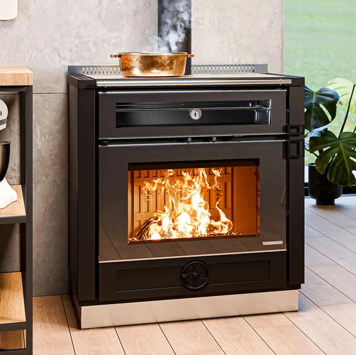 Modern black stove with visible flames inside, placed on a wooden floor.