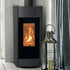 A modern matt black wood-burning stove with a black glass front door showing a glowing orange fire, set against a white paneled wall next to a silver metal lantern.