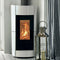 Modern white fireplace with visible flames, next to a decorative lantern in a room with striped wallpaper.