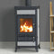 Wood burning stove with flames inside, placed against a gray wall.