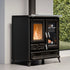 Black freestanding stove with visible flames inside, set against a neutral wall with greenery.