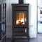 A dark charcoal gray wood-burning stove with a lit fire visible through the front glass door, set against a white wall in an interior room.