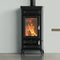 A black wood-burning stove with a glass front door showing a bright orange fire, set against a light gray wall and floor.