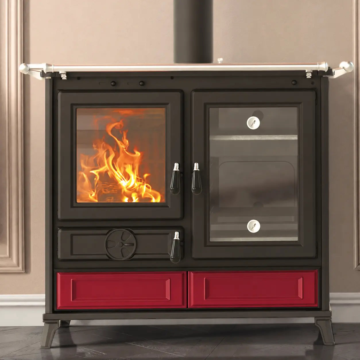 A black cast iron wood stove with a bright orange fire burning in the left oven door shown against a neutral beige wall.