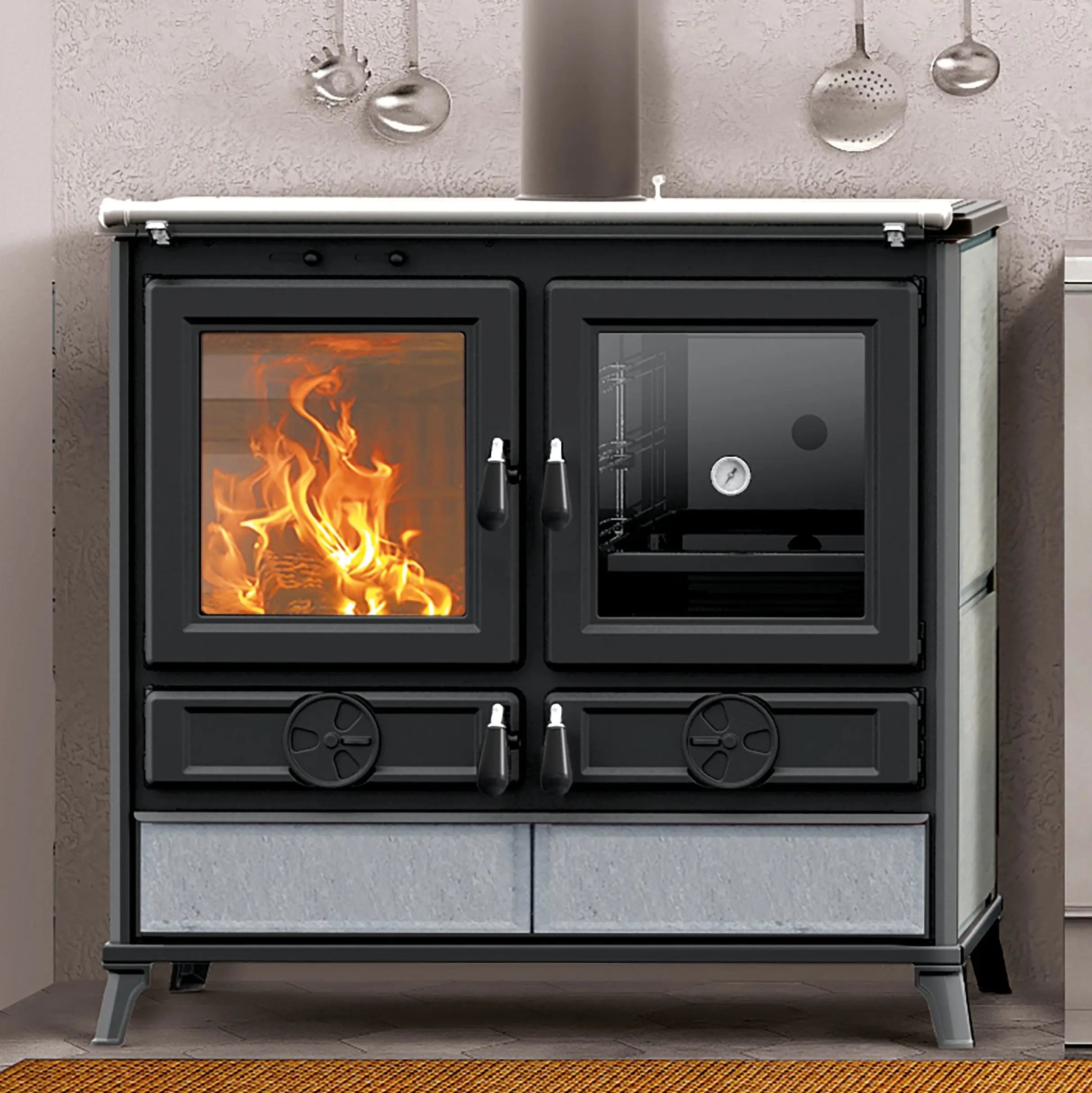 A black freestanding wood-burning stove with glass doors, shown lit with visible orange flames. The stove has two upper doors, two lower drawers with decorative circular details, and a light gray stone base panel.