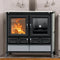 A black freestanding wood-burning stove with glass doors, shown lit with visible orange flames. The stove has two upper doors, two lower drawers with decorative circular details, and a light gray stone base panel.